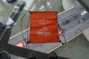 This Mailbox bag has gone international! It's resting on the glass walkway at the Tower Bridge in London. Check out the cars below that are crossing the Thames River!